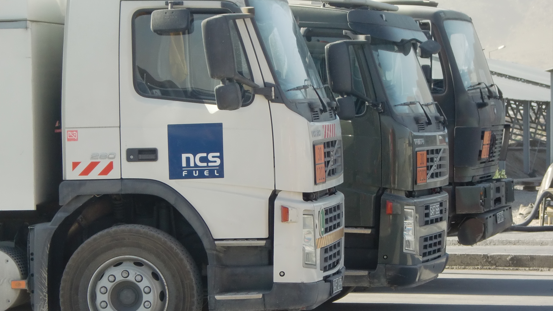 Three trucks parked next to each other